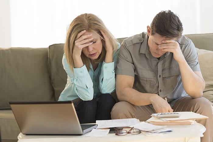 couple worried with hands in on their head