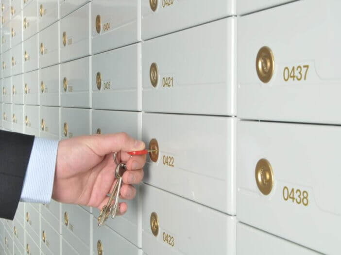 man opening po box with key