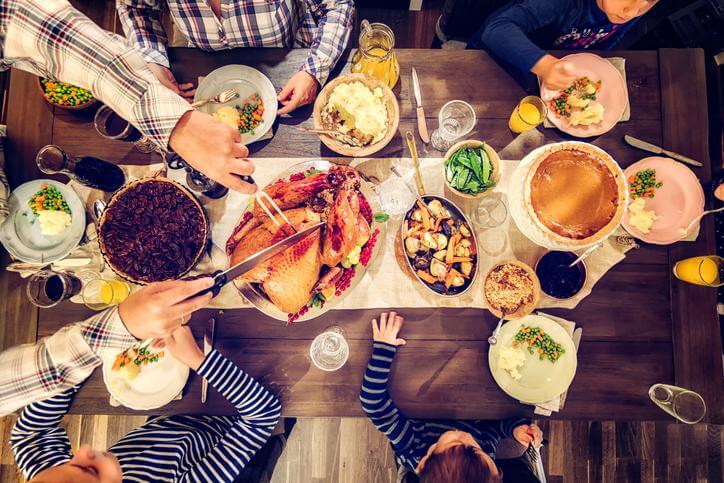 family sitting at thanksgiving dinner