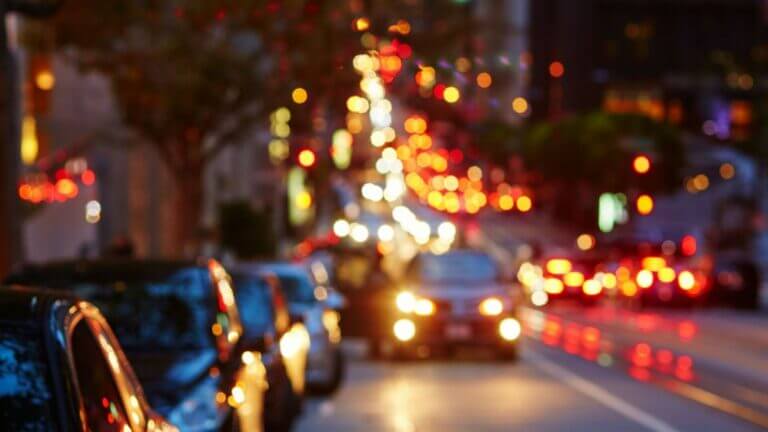 blurry night time picture with headlights and cars