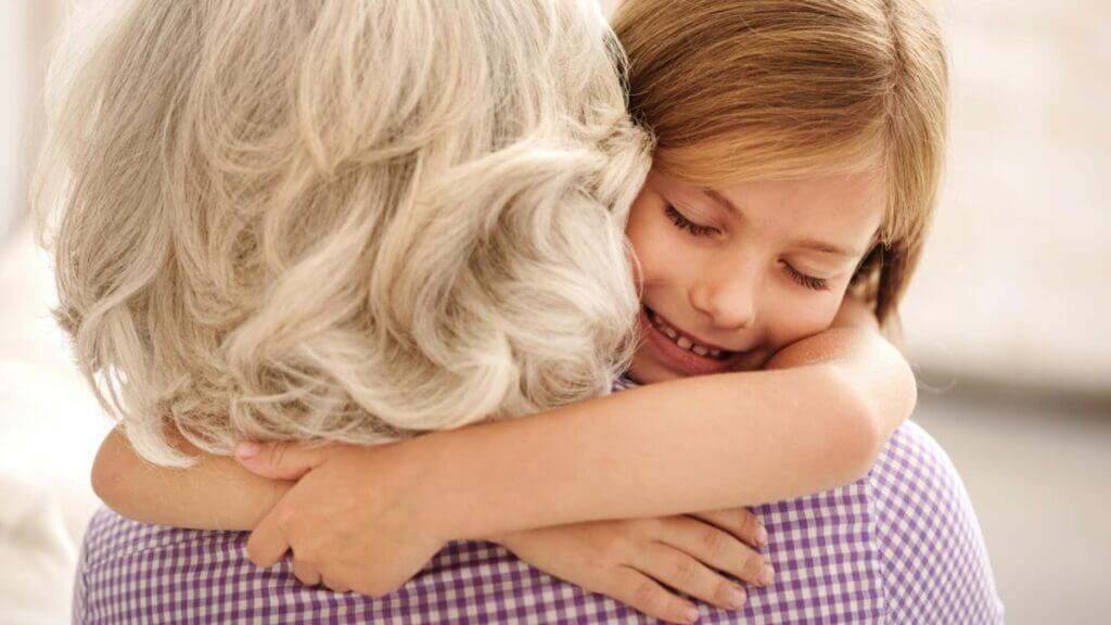 grandmother and granddaughter hugging
