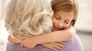 grandmother and granddaughter hugging