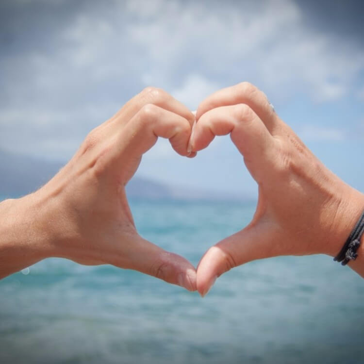 two people making a heart with their hands