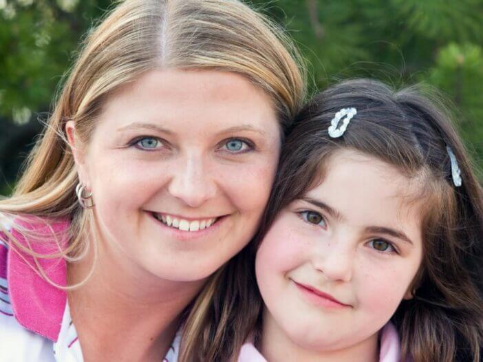 mom and daughter smiling