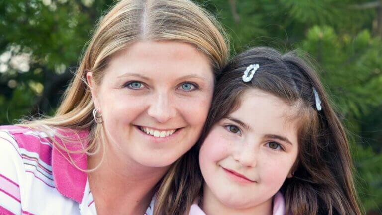 mom and daughter smiling