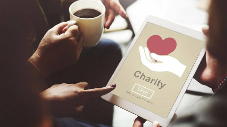Give to charity sign with cup of coffee