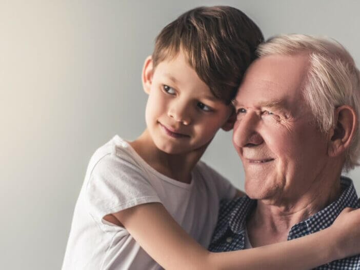 grandfather and grandson hugging