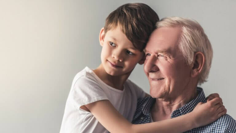 grandfather and grandson hugging