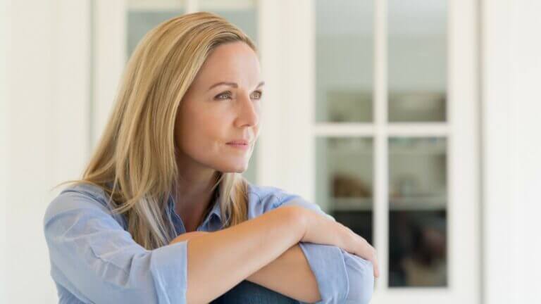 women with arms crossed gazing out to the right