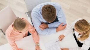 couple meeting with attorney going over paper work