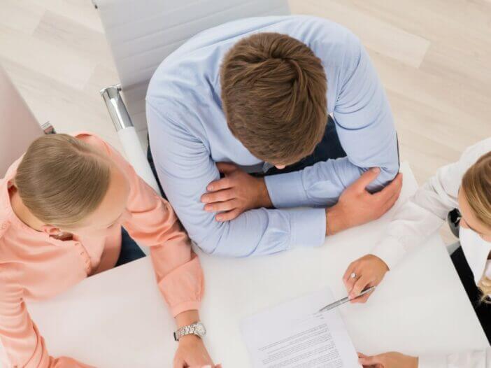 couple meeting with attorney going over paper work