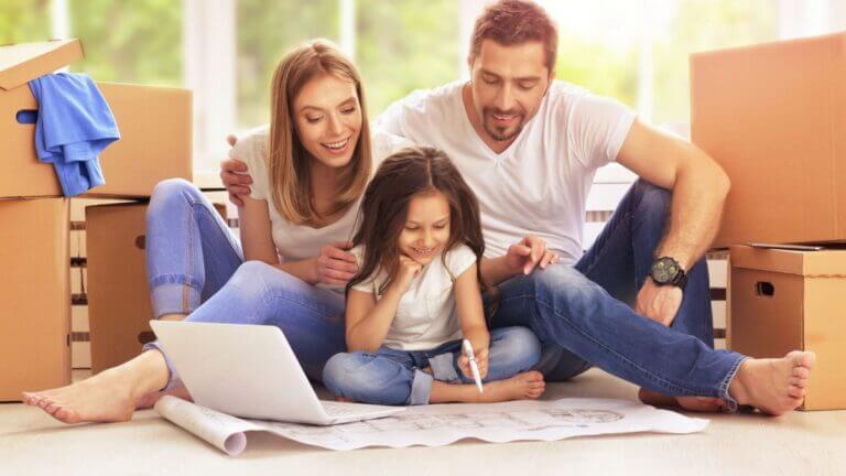 mom and dad with child looking at blue prints