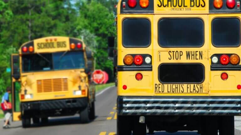 two school busses driving