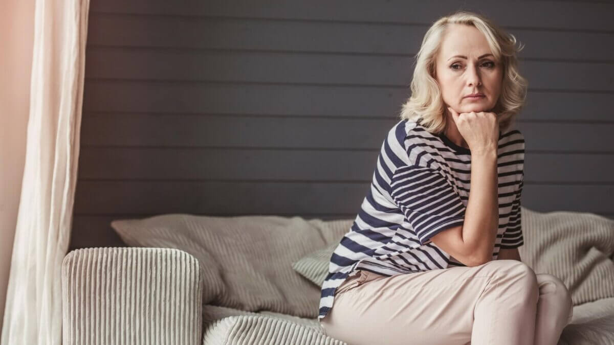 woman with arm under chin thinking