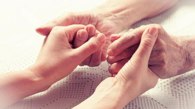 an old person and a young person holding hands