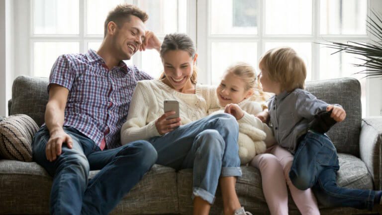 parents and young children on couch together