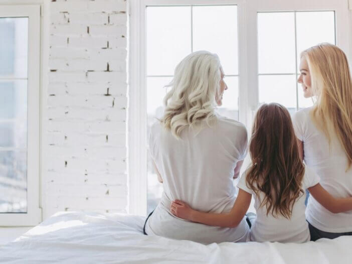 3 generations of women hugging each other