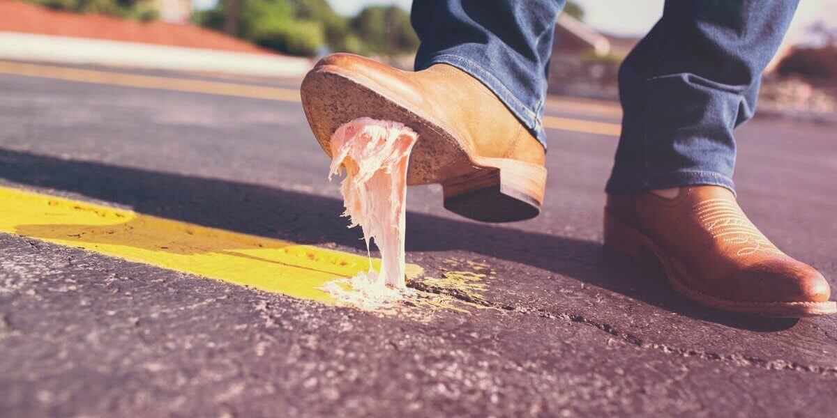 boot stepping in gum on road