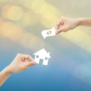 Business concept Hand hold white paper house and money