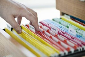 hand with financial documents in folders