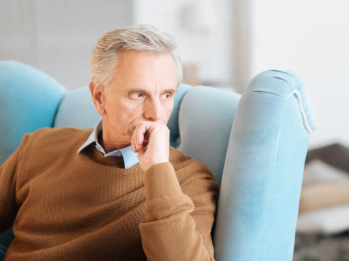 Pensive retired man recalling his memories