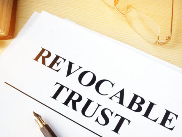 Revocable trust on a wooden desk.