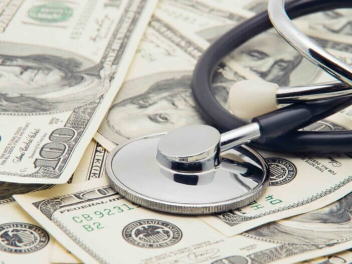 heap of dollars with stethoscope