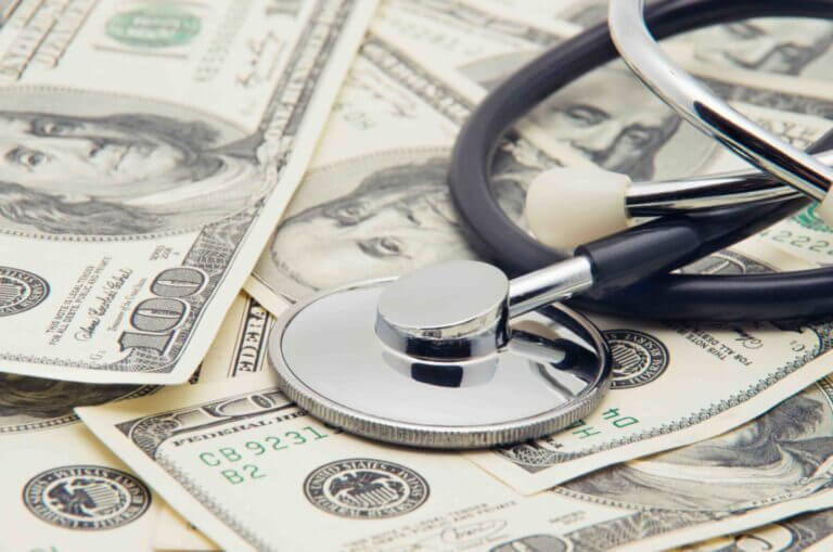 heap of dollars with stethoscope