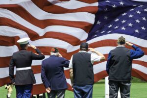 Soldier and Veterans Saluting at Memorial Day Ceremony