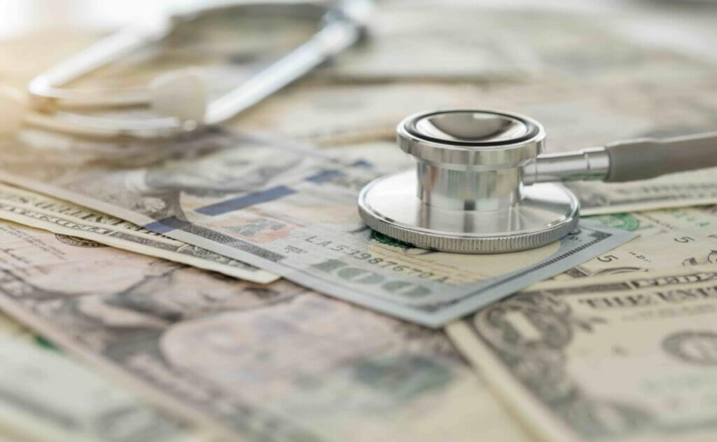 medical cost, stethoscope on dollar banknote money. concept of health care costs, finance, health insurance funds.