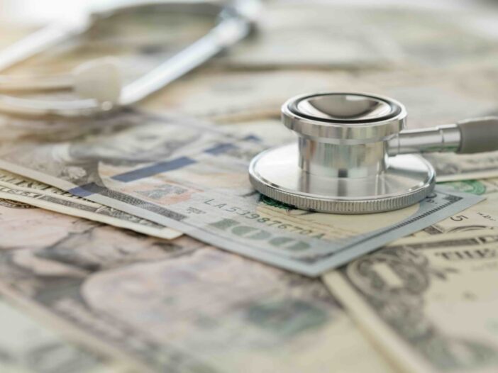 medical cost, stethoscope on dollar banknote money. concept of health care costs, finance, health insurance funds.