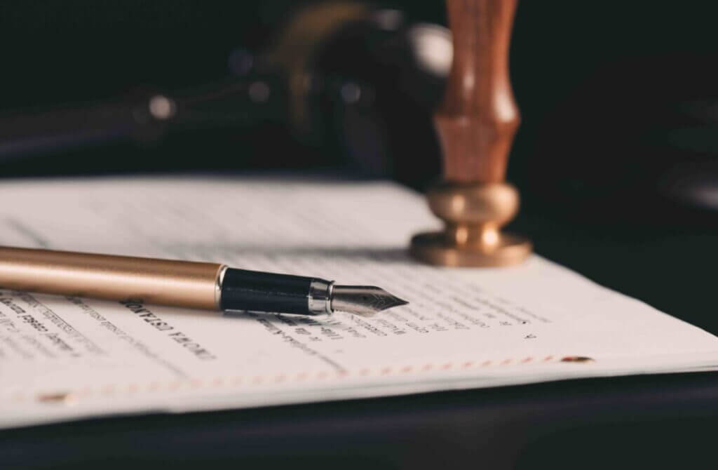 Law, notary background theme. Fountain pen and handmade paper on desk
