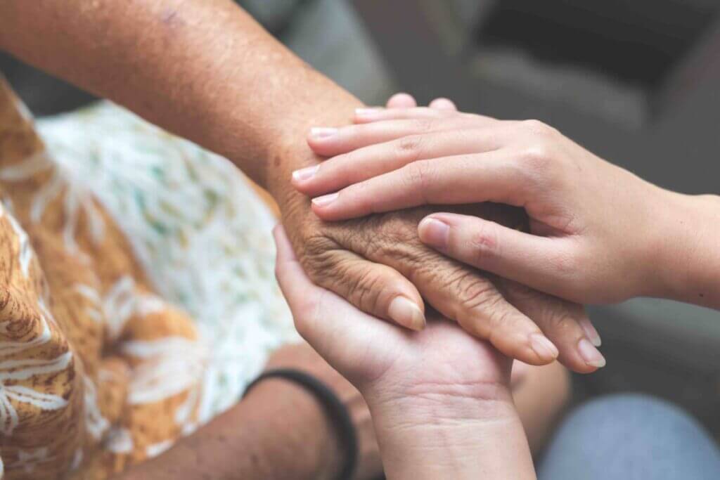 Old and young holding hands, Care for the elderly concept