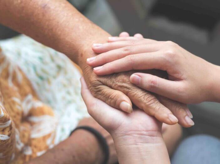 Old and young holding hands, Care for the elderly concept