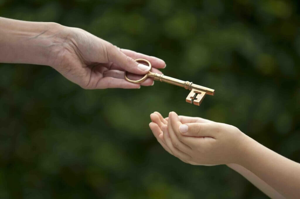 mother handing key to daughter