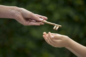 mother handing key to daughter