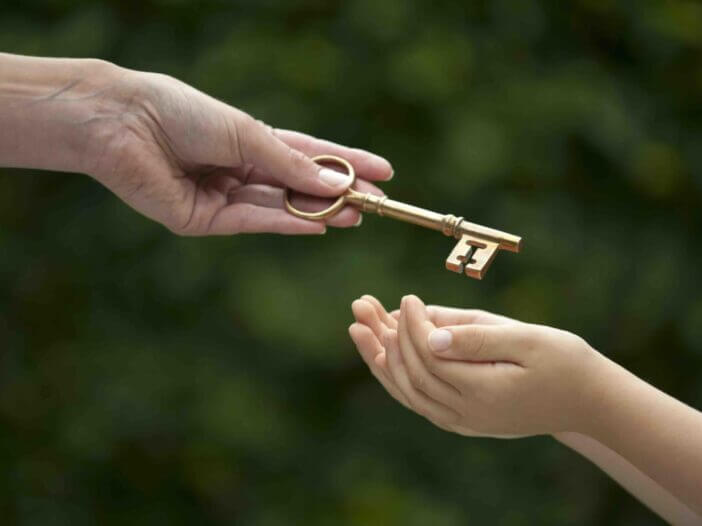 mother handing key to daughter