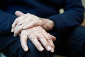 Close Up Of Senior Man Suffering With Parkinson’s Disease