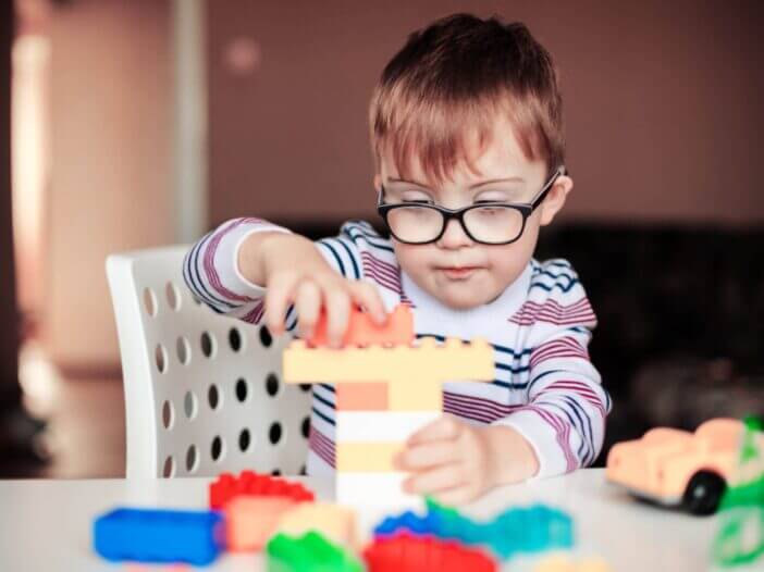 little boy with special needs playing with lego