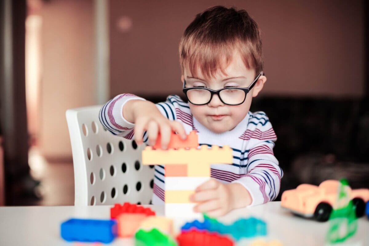 little boy with special needs playing with lego