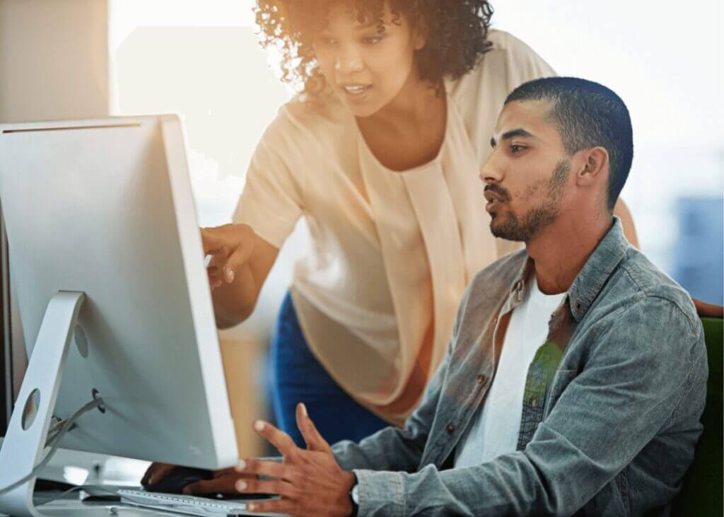 two people looking at a computer