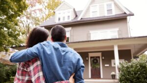 couple looking at front of house