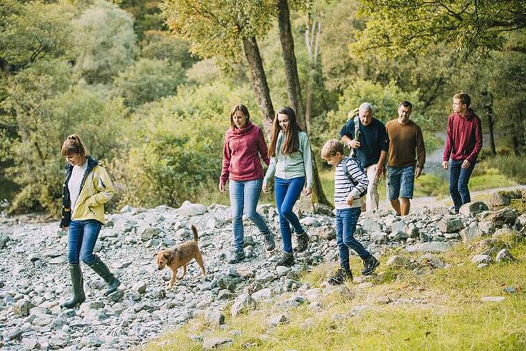 family with multiple generations on a hike