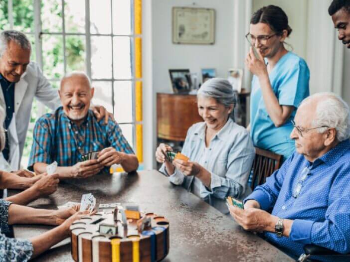 seniors playing cards at the table