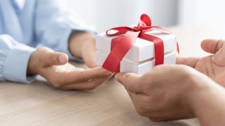 two people holding a present