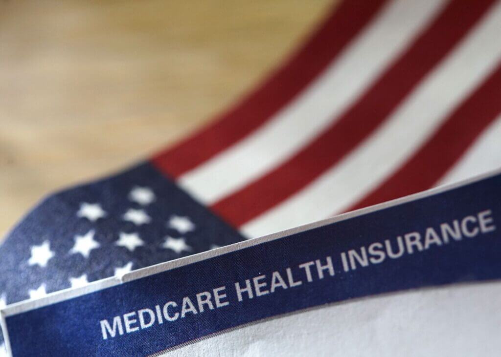 US flag with medicare insurance paperwork