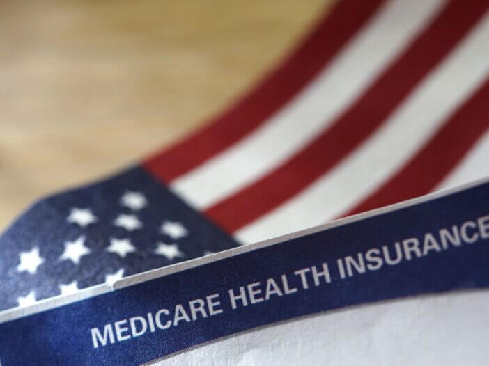 US flag with medicare insurance paperwork