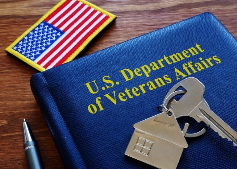 Blue booklet on a desk with an american flag patch and keys to a house