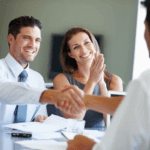 married couple shaking hands with professional
