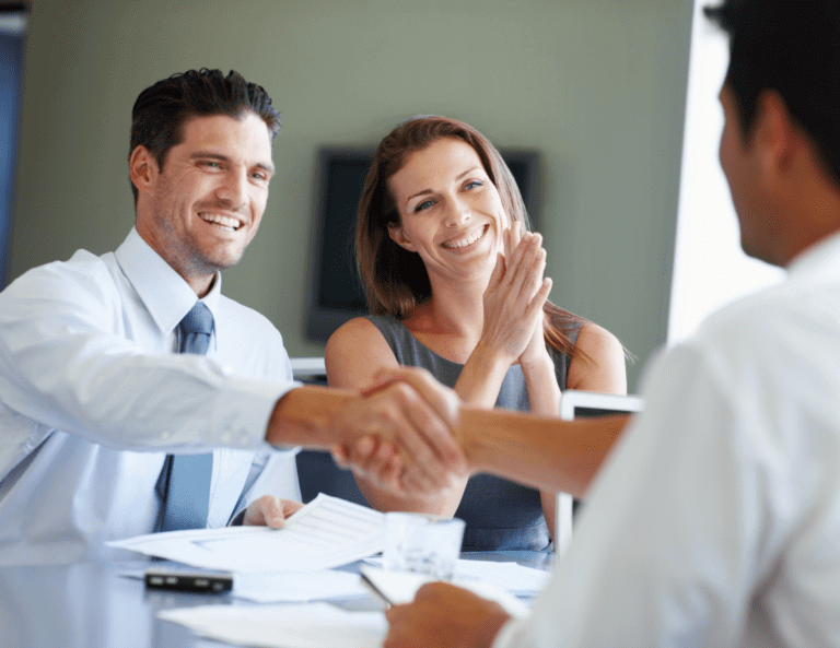 married couple shaking hands with professional